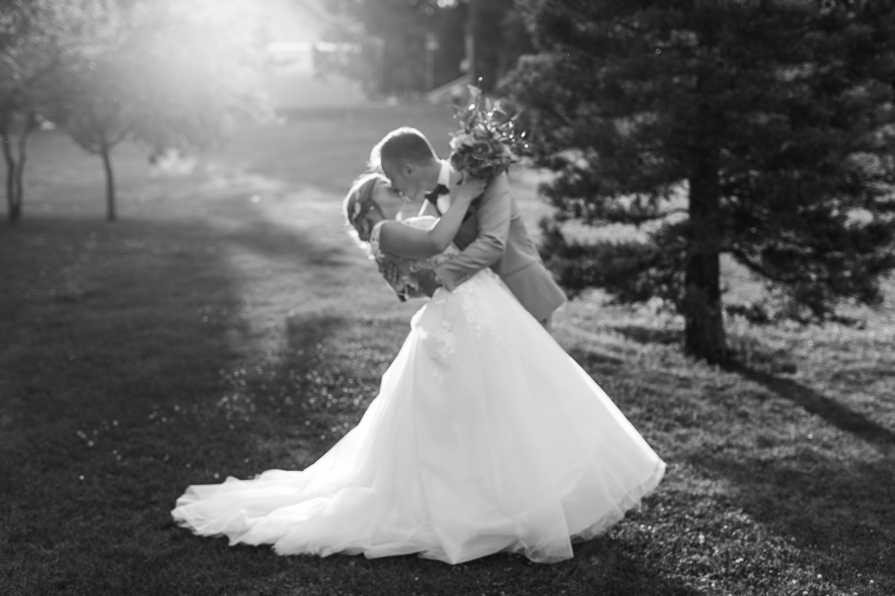 Unscharfes schwarz-weiß Bild eines sich küssenden Brautpaares