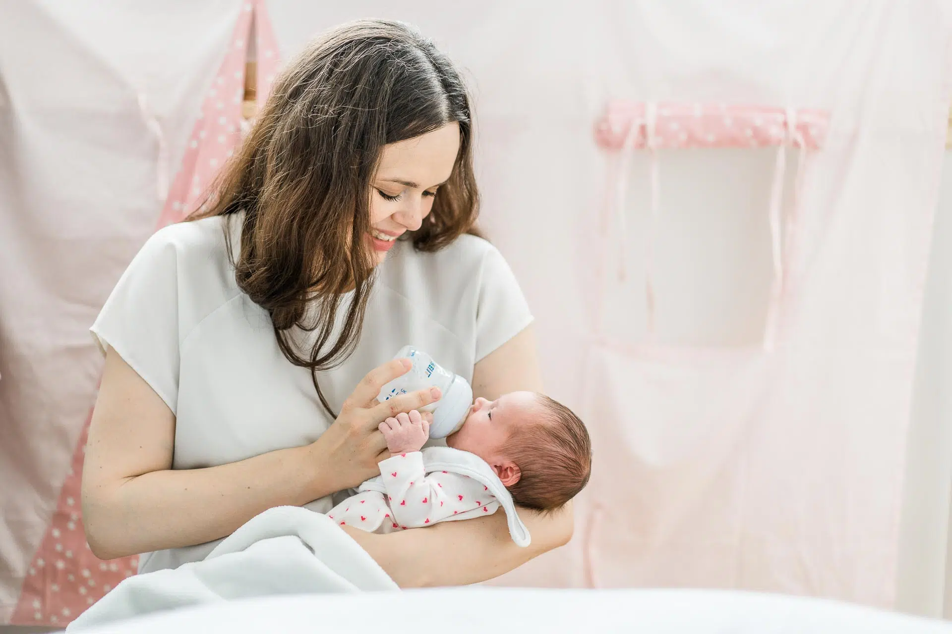 Newborn-Geschenk- Carmen-Trappenberg-Fotografie-1 Eine Frau füttert ein Baby mit einem Fläschchen